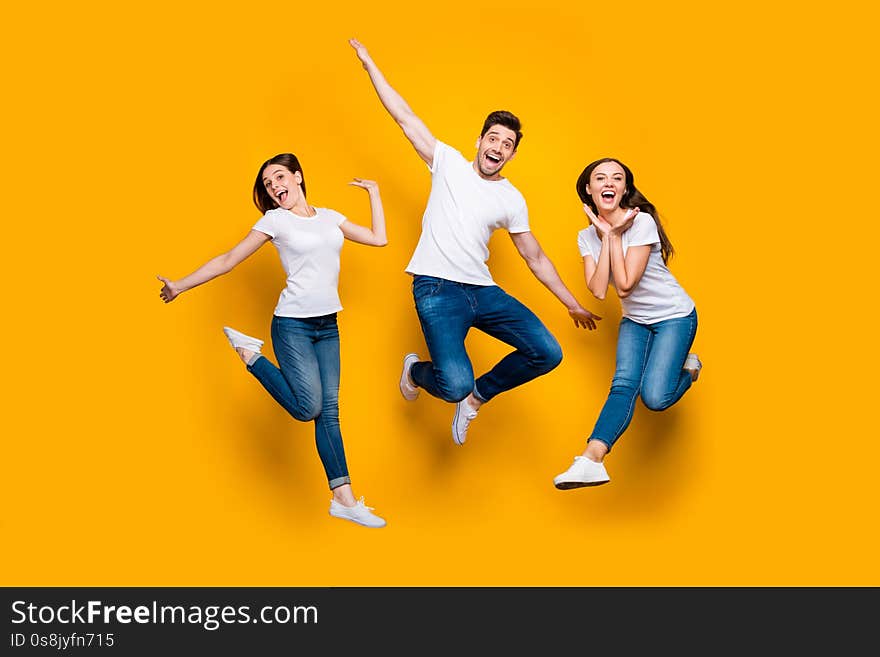 Full length body size view portrait of three nice attractive slim cheerful cheery comic foolish carefree careless person buddy fellow, having fun isolated over bright vivid shine yellow background