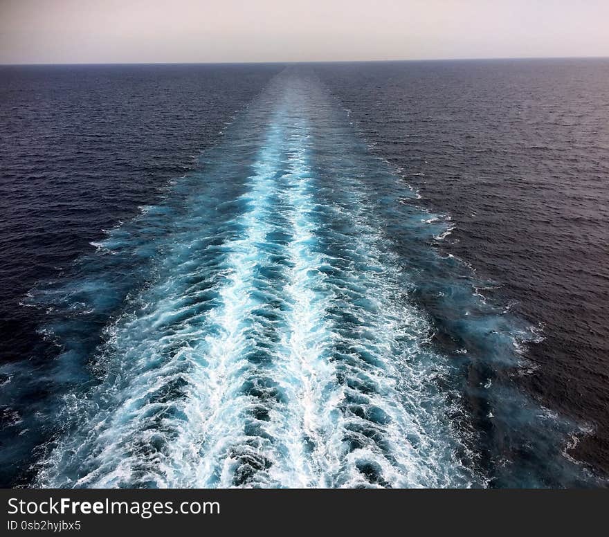 Cruise ship propeller wash on blue ocean sea