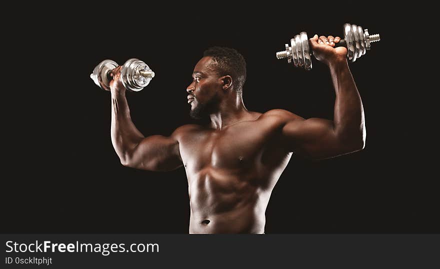 African Bodybuilder Working Out, Pushing Barbells Up