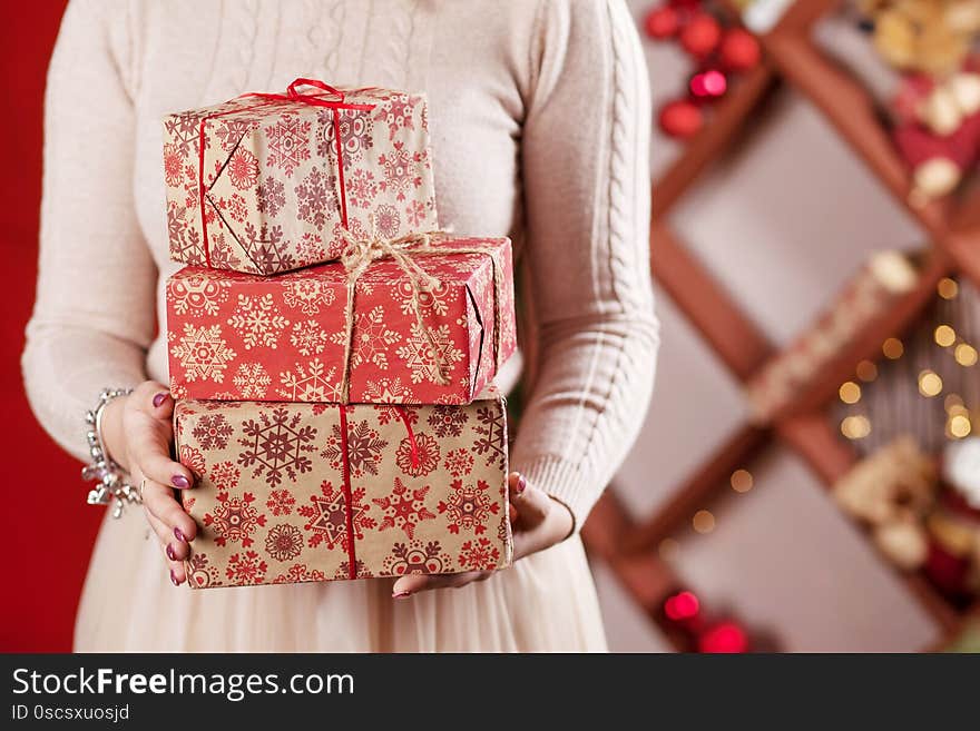 Woman`s  hands holding gift boxes. Christmas, new year, birthday concept. Festive background with bokeh and sunlight. Magic fair