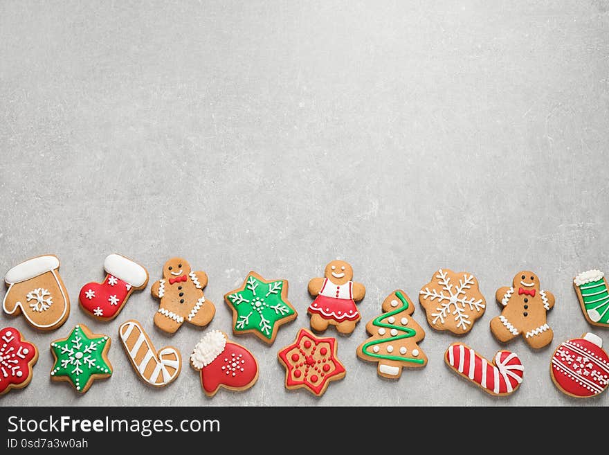 Flat lay composition with tasty homemade Christmas cookies on grey table, space for text