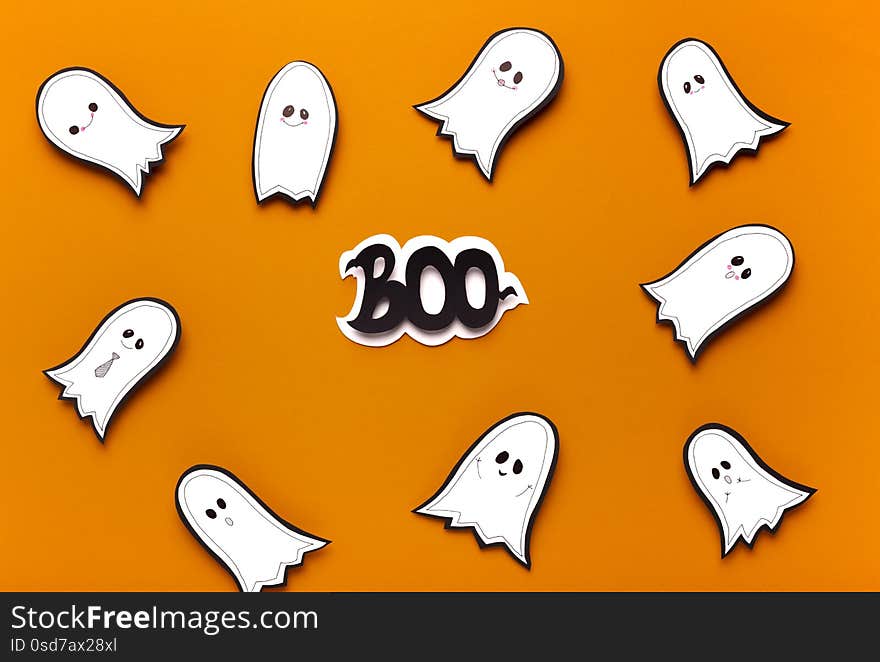 Spooktacular Halloween ghosts flying on orange background with boo scary text