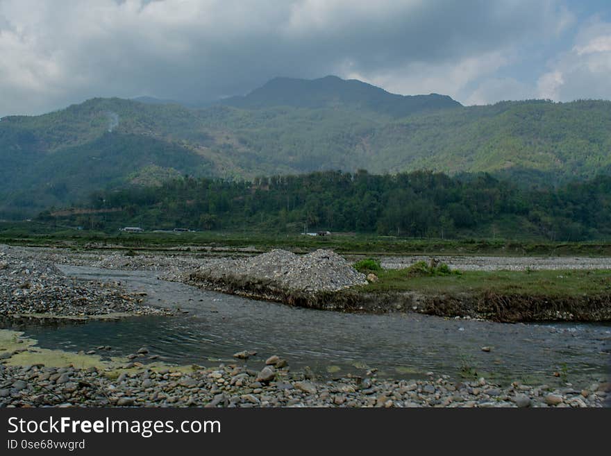 Beautiful landscape of rocky flooded road on the way up into mountains