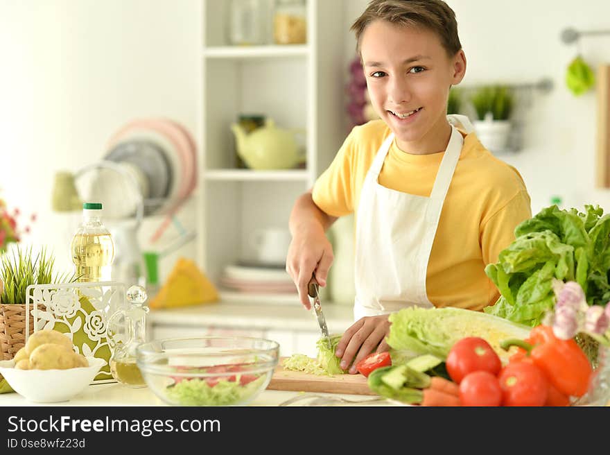 Portrait of cute boy preparing cooking at home