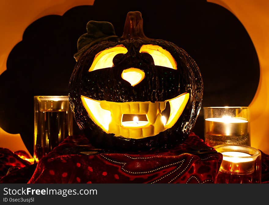 Halloween Pumpkin, scary Jack O`Lantern on black cloud background