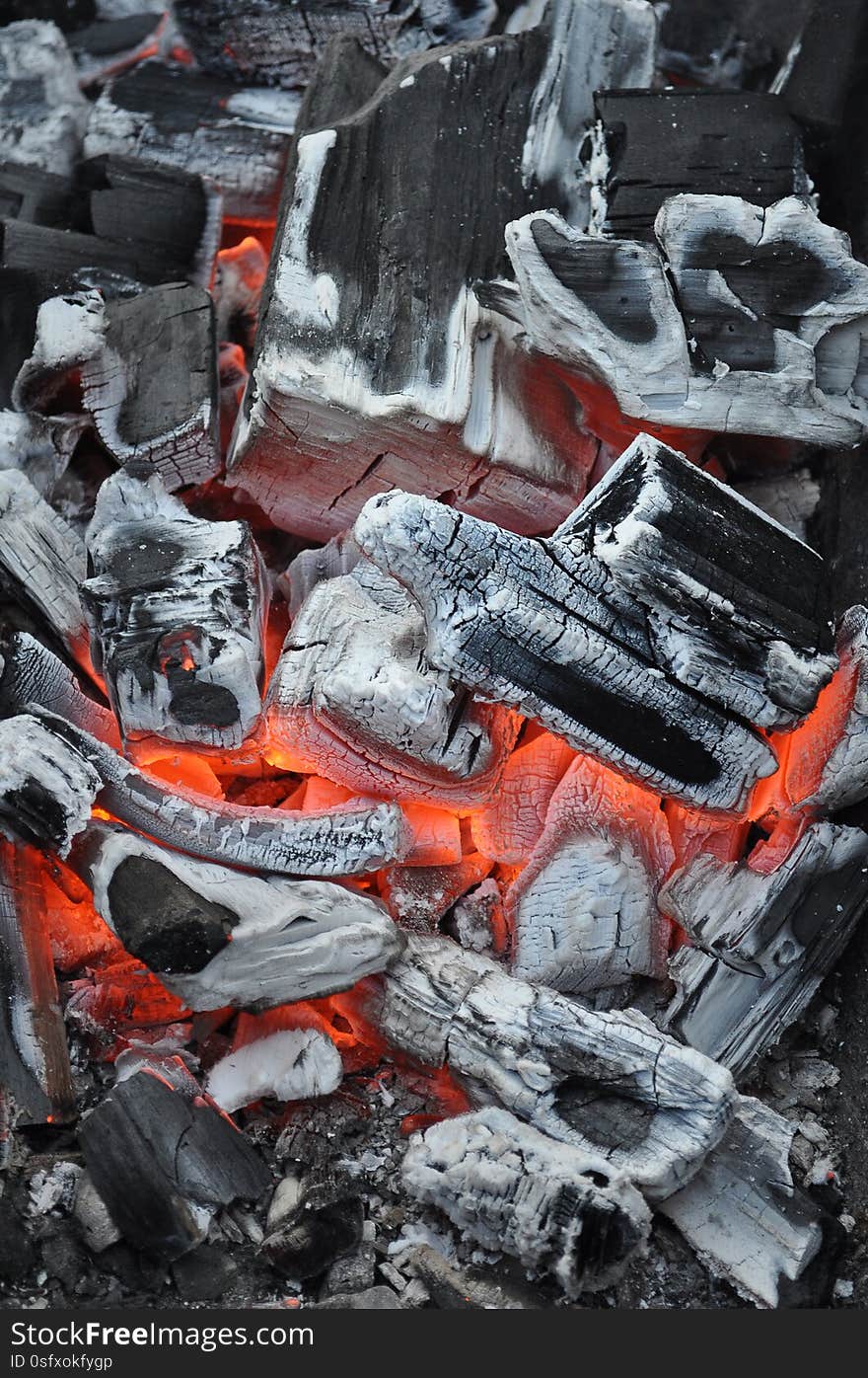 Smoldering hot coals from wood and gray ash. Smoldering hot coals from wood and gray ash