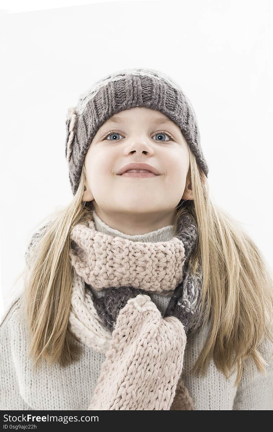 Adorable little girl in cap and scarf imagination. Winter style.