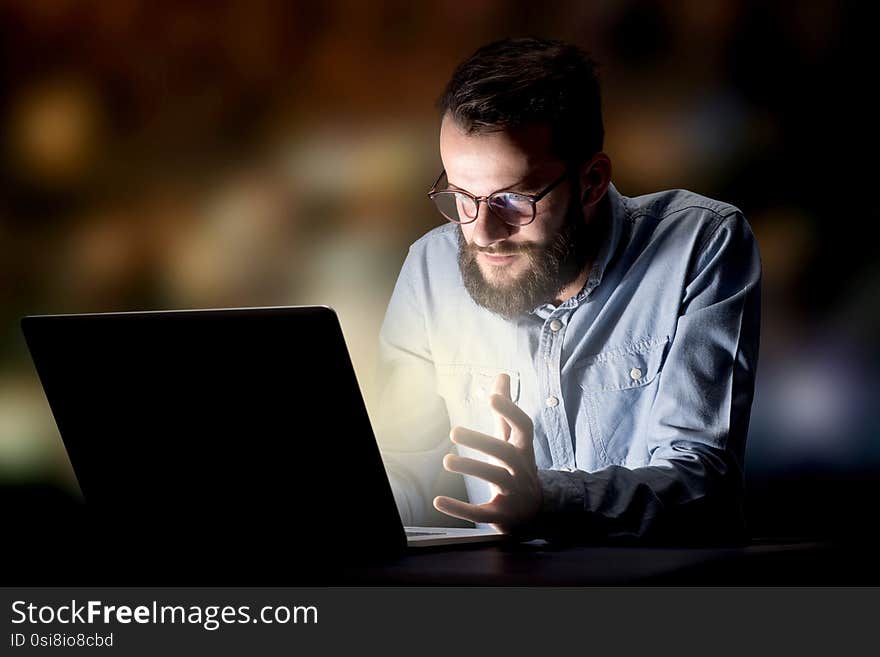 Young handsome businessman working late at night in the office. Young handsome businessman working late at night in the office