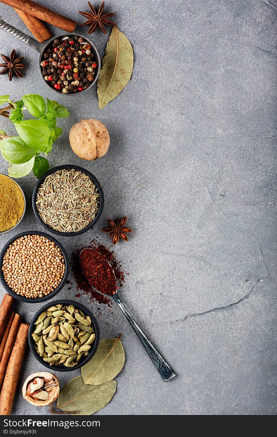 Wooden table of colorful spices. Top view. Dark background