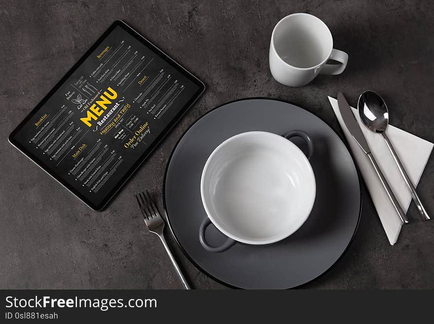 Tableware with online menu on tablet