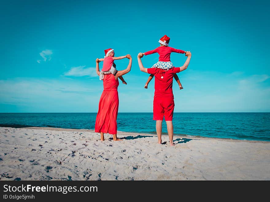 Happy family-mom, dad and kids- on tropical Christmas vacation