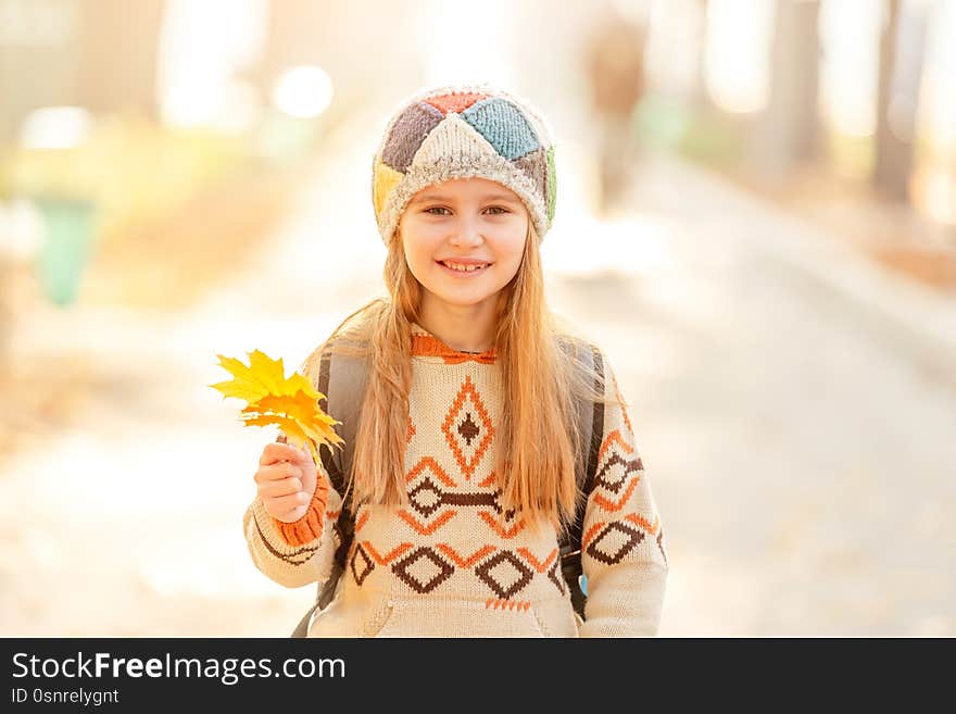 Cute school girl with leaves