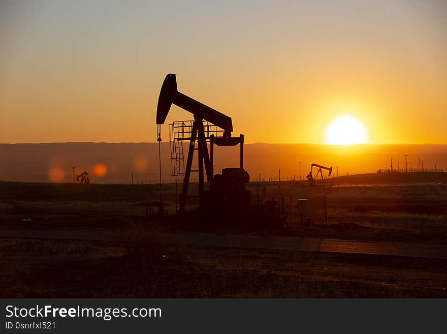 View of Oil Well Pumpjack Horsehead at Sunset Oil Industry. View of Oil Well Pumpjack Horsehead at Sunset Oil Industry