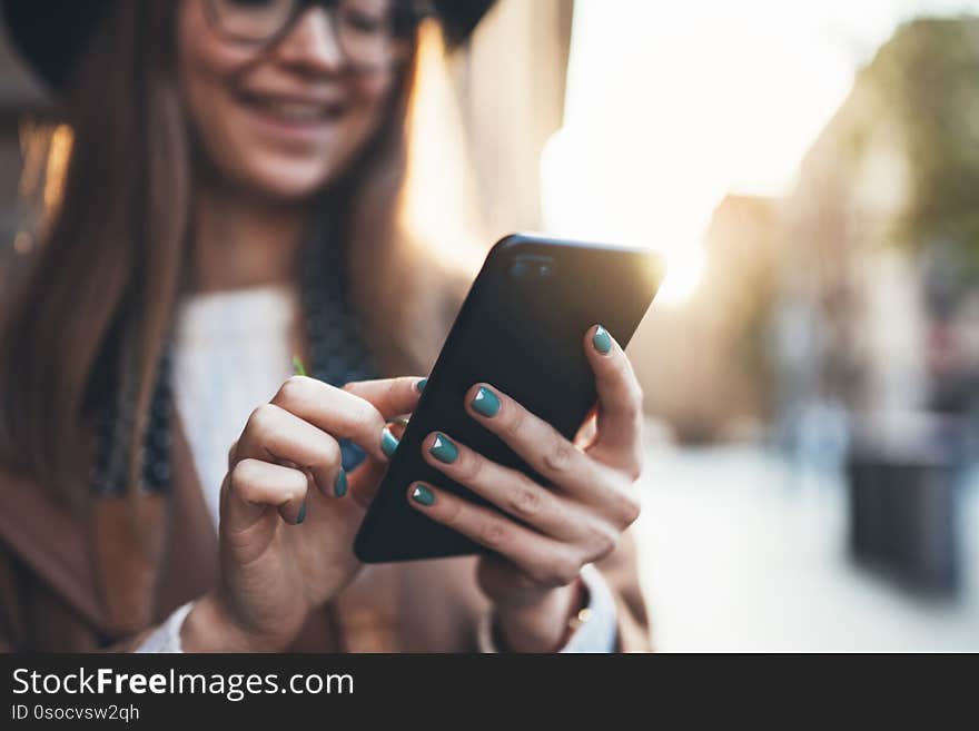 Closeup technology smartphone online connect. Traveler woman holding in hands mobile phone. Girl tourist in glasses using gadget