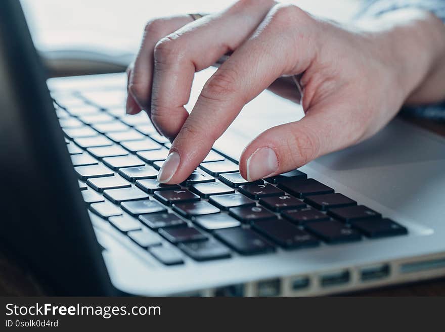 Woman working at home office hand on keyboard close up