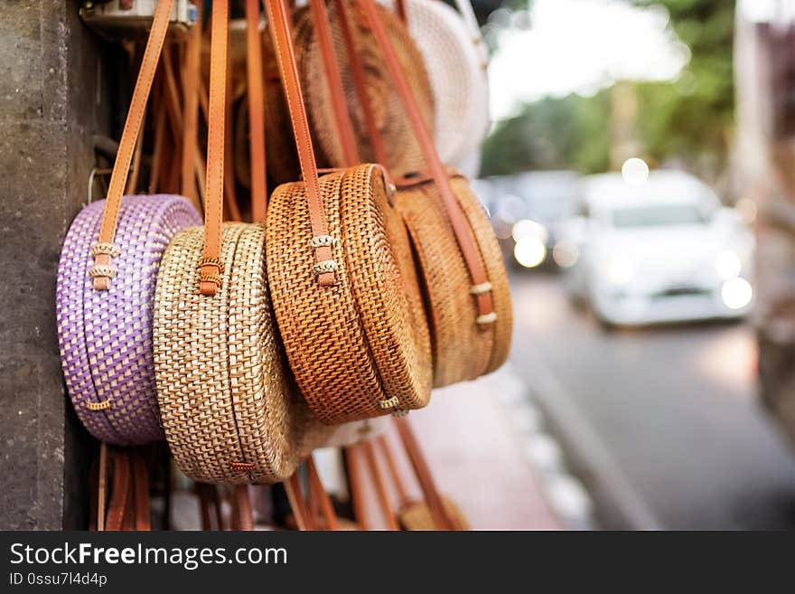 Stylish rattan handbags on the balinese street in Ubud. Bali island.