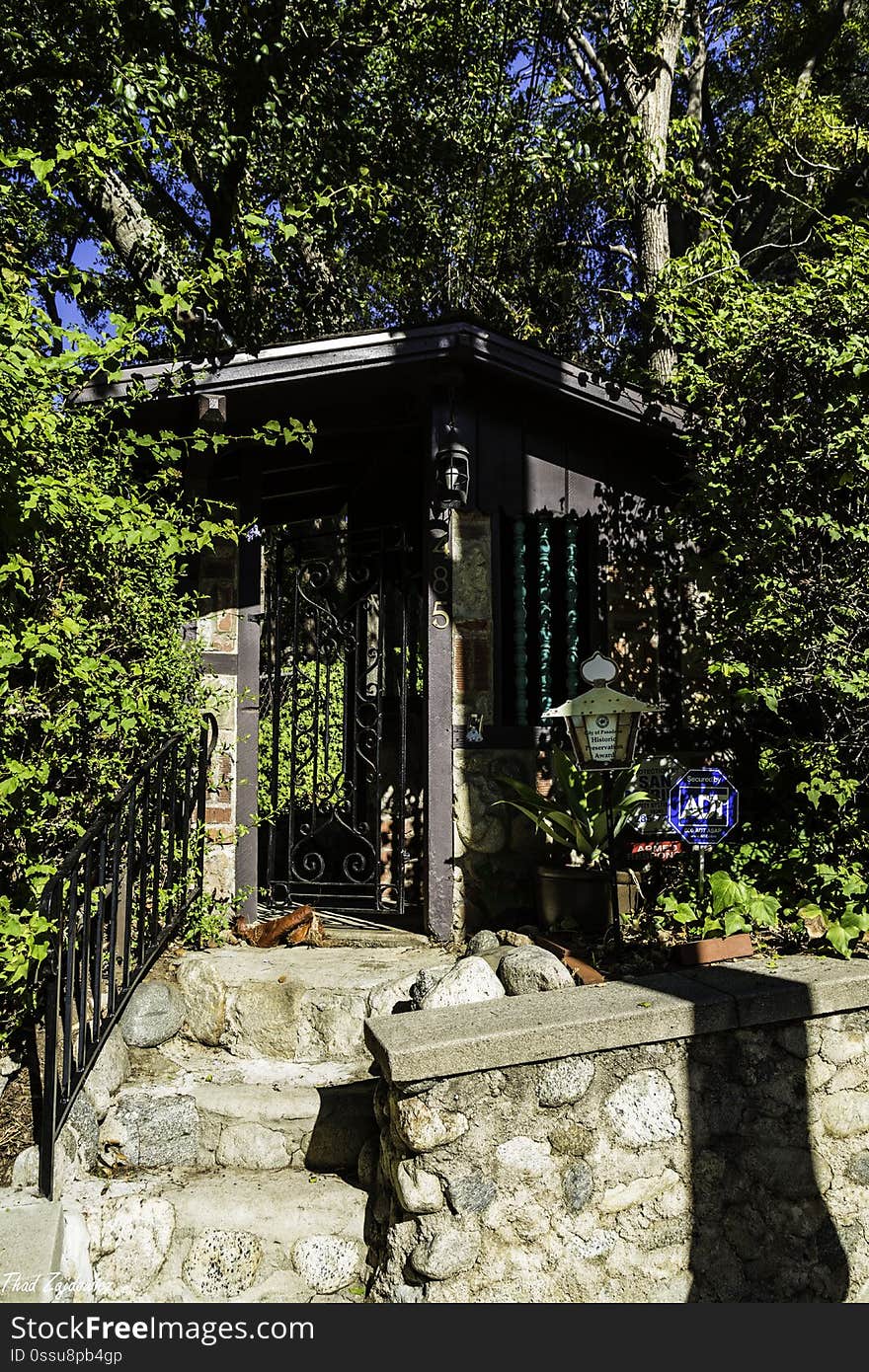 This little stone entrance-way is intriguing. It actually was a ticket booth to enter Busch Gardens in the early 20th century. The home on the property &#x28;not visible from the street&#x29; incorporates the remnants of the Old Mill, a European style windmill, that was part of the gardens. Pasadena, California. This little stone entrance-way is intriguing. It actually was a ticket booth to enter Busch Gardens in the early 20th century. The home on the property &#x28;not visible from the street&#x29; incorporates the remnants of the Old Mill, a European style windmill, that was part of the gardens. Pasadena, California