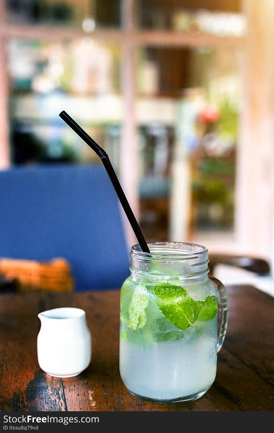 Fresh drink lemonade mojito on wooden table. Mojitos with mint leaves, lime and ice, outdoor. Bali island. Fresh drink lemonade mojito on wooden table. Mojitos with mint leaves, lime and ice, outdoor. Bali island.