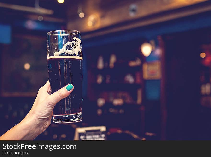 Woman hand with glass of beer