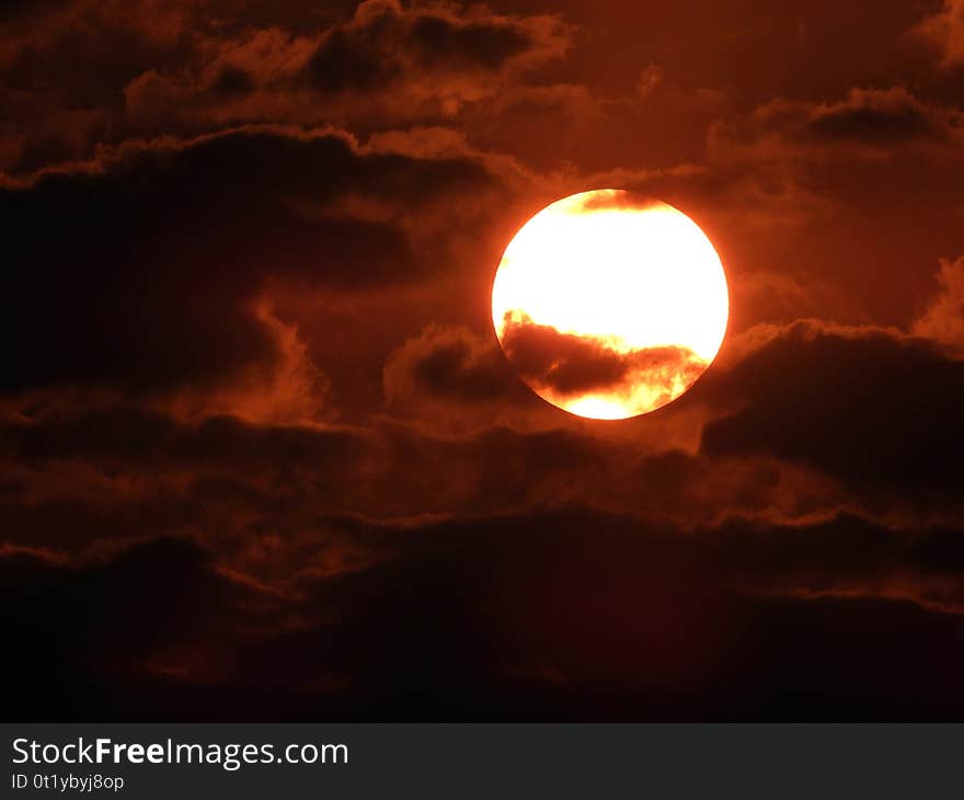 Bright sun and the clouds in the sky in the afternoon ,close to night , in China. Bright sun and the clouds in the sky in the afternoon ,close to night , in China