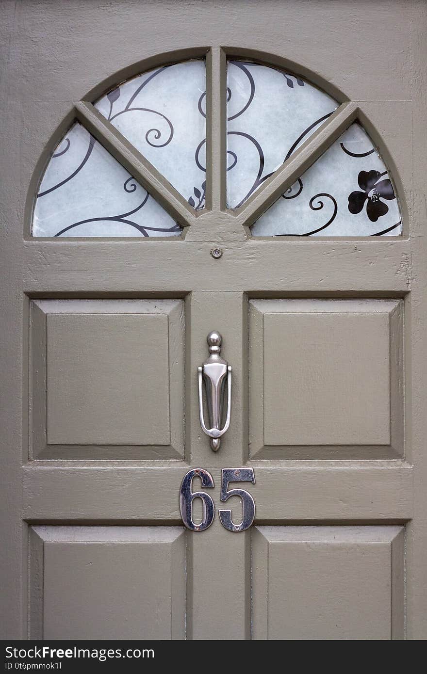 Elegant front door with the number 65