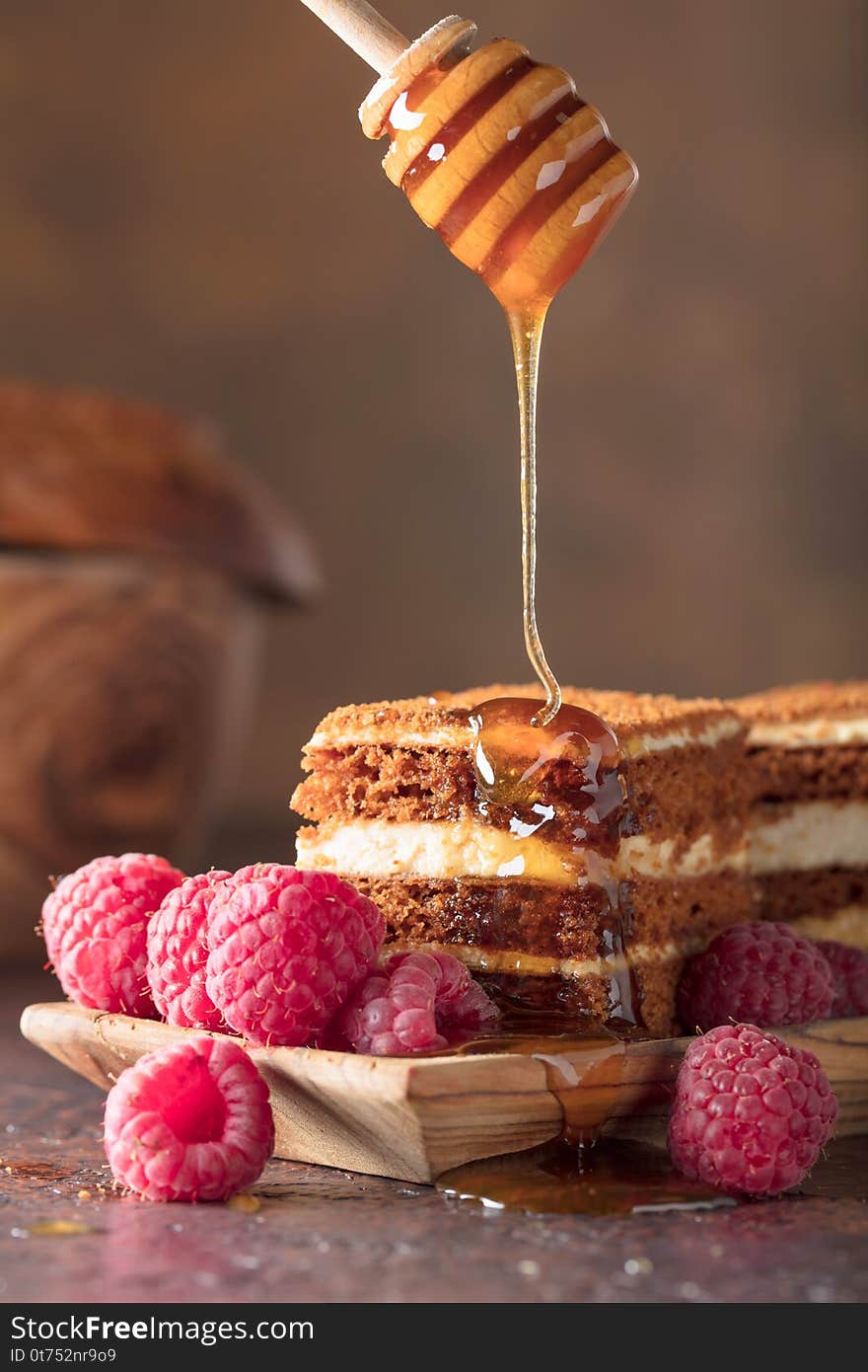 Layered honey cake with cream and raspberries