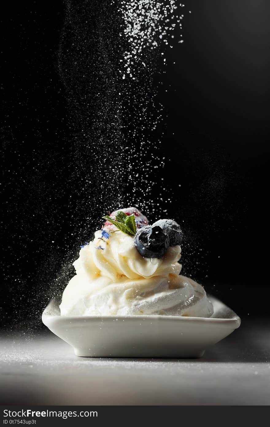 Dessert Pavlova  sprinkled with powdered sugar