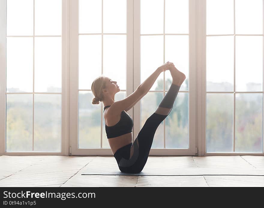 Well balanced young girl stretching body at yoga studio