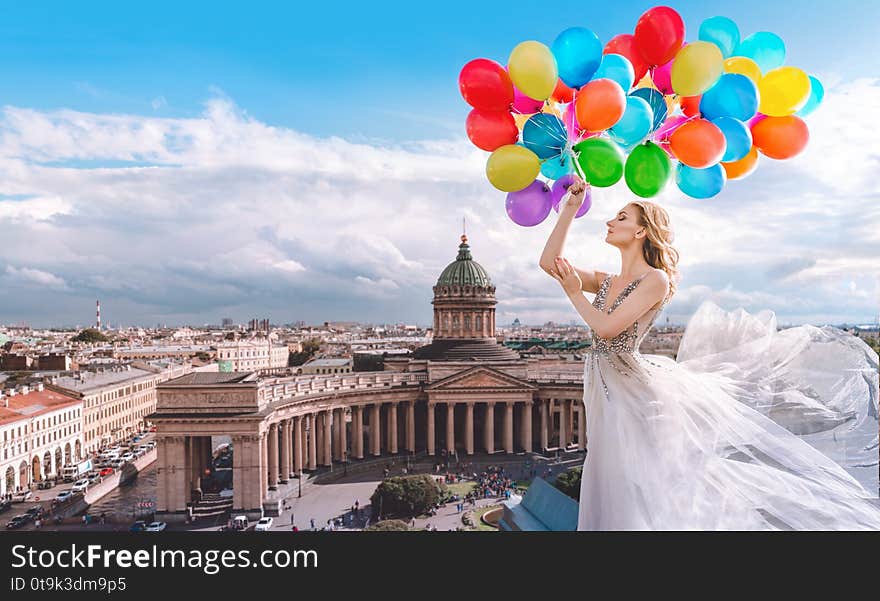 Woman with balloons in a waved dress on the background of St. Petersburg, Russia. Kazan Cathedral