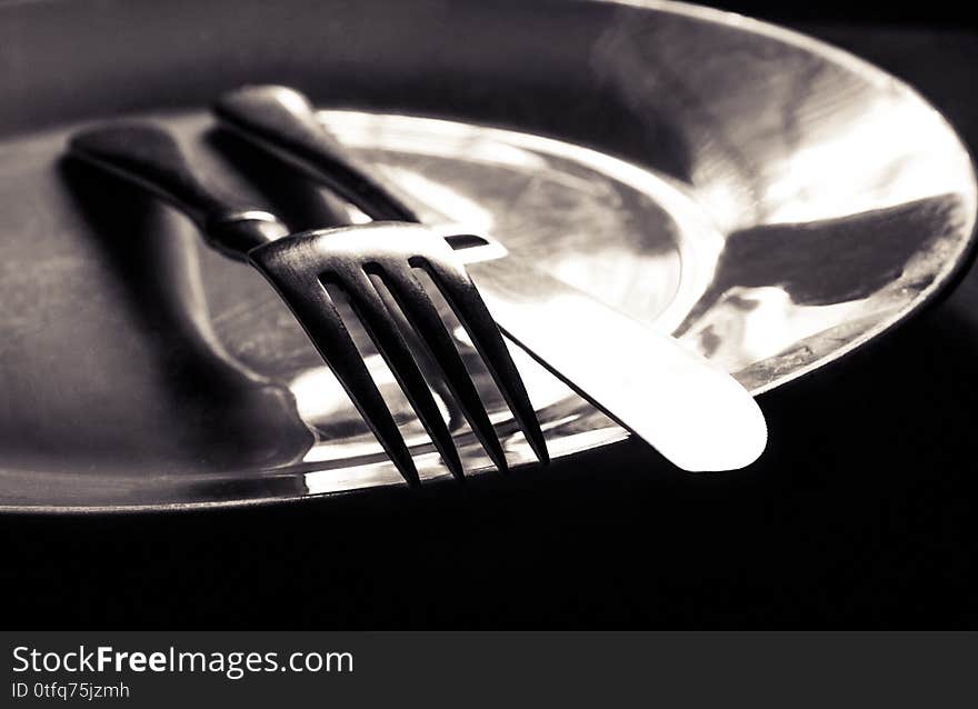 Plate with a Knife and fork on top