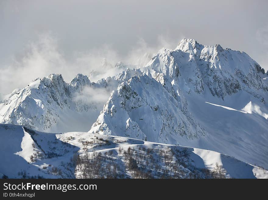 Snowy high mountain peak above the clouds. Snowy high mountain peak above the clouds