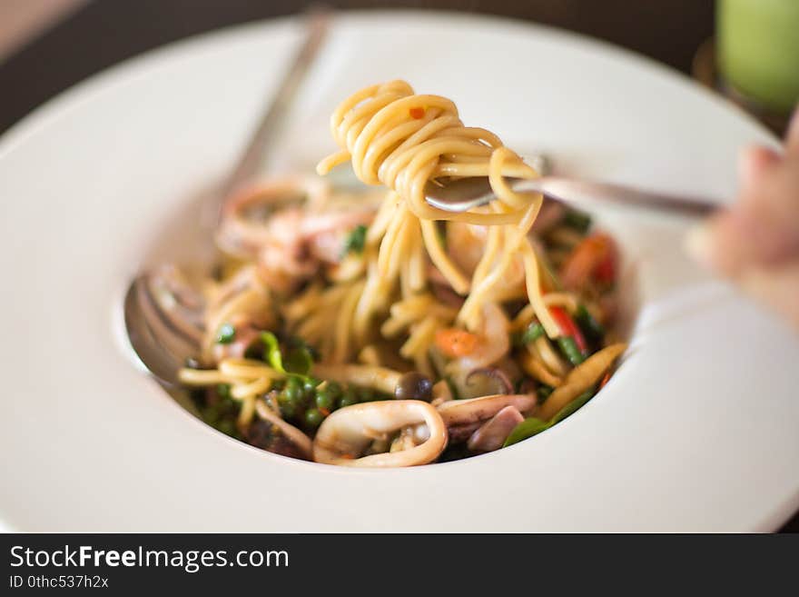 Selective focus of Seafood spaghetti in  a white plate