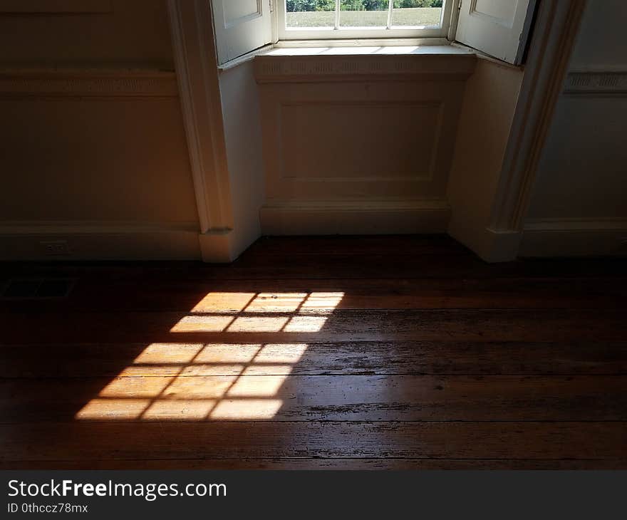 Light from glass window shining on wood floor. Light from glass window shining on wood floor