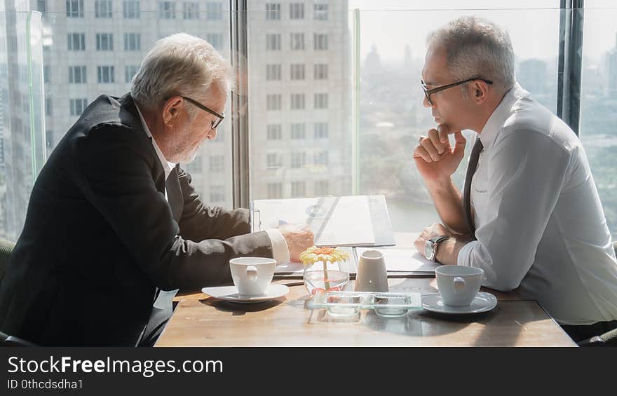 Business background of cacasian businessman having business discussion in business lounge