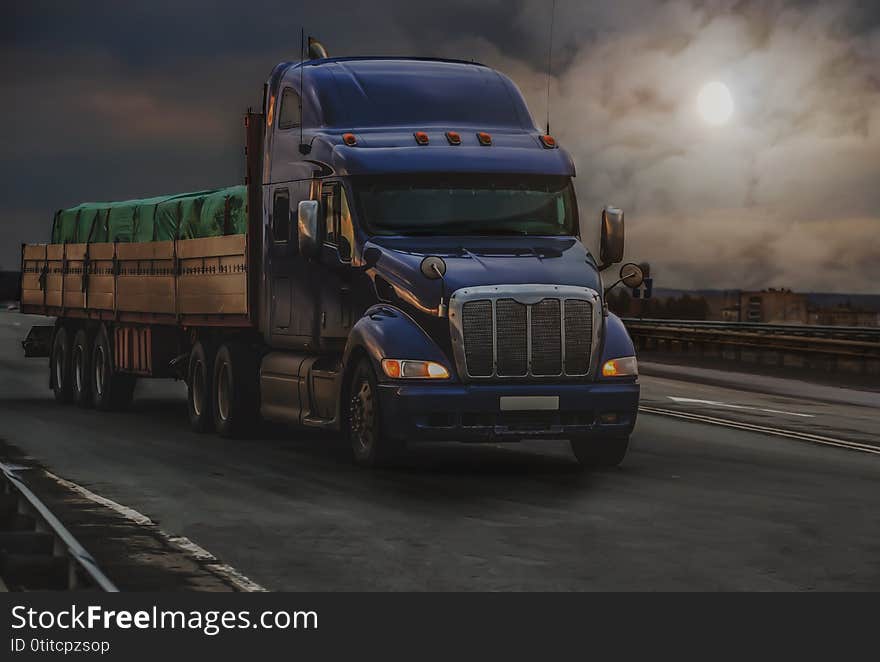 Large truck transports a grug along a road