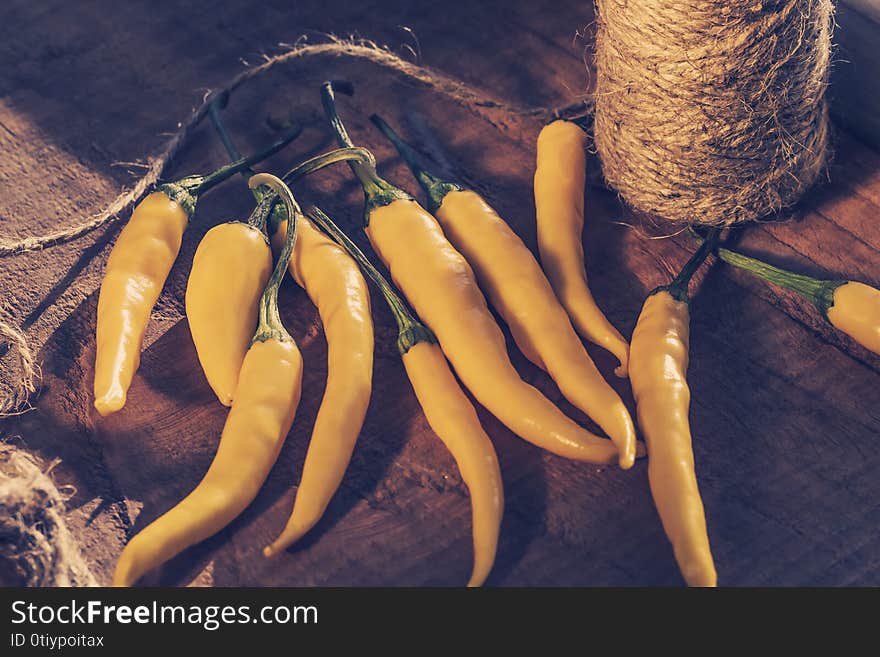 yellow chilli peppers with thread, concept of harvesting peppers for the winter, healthy eating concept, harvest concept.