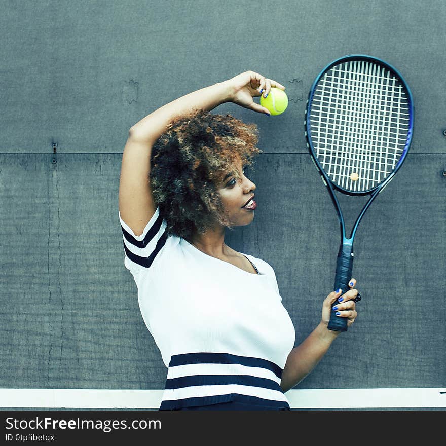 Young stylish mulatto afro-american real girl playing tennis, sport healthy lifestyle people concept