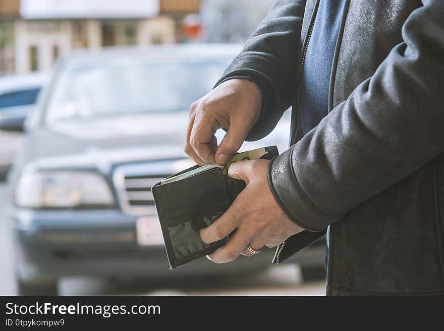 Man pulls money out of his wallet. Man pulls money out of his wallet