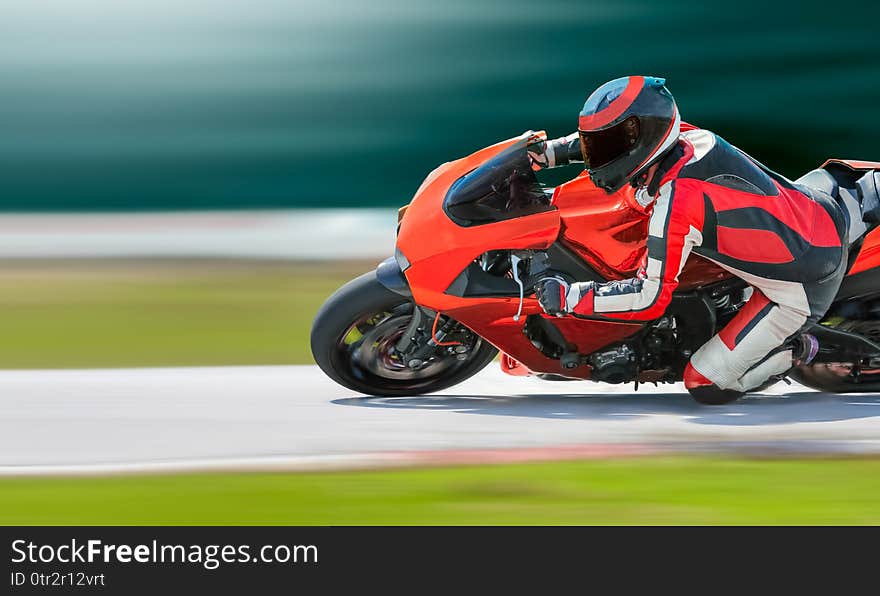Close up Motorcycle leaning into a fast corner on race track