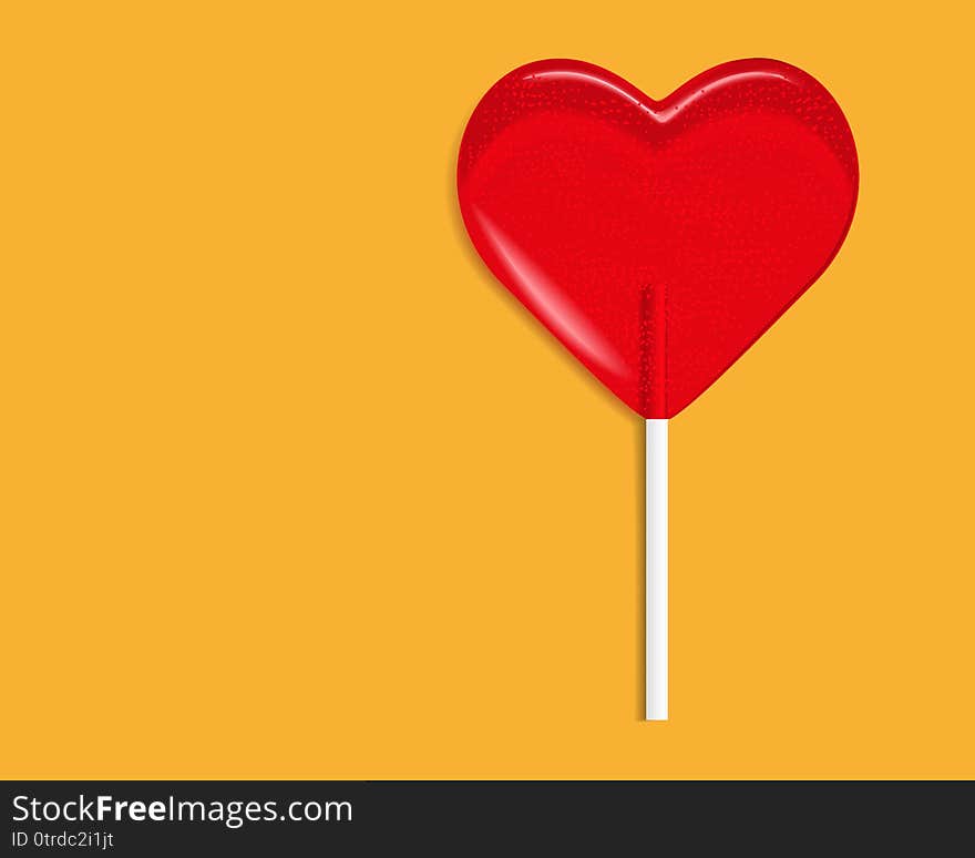 Heart lollipop candy isolated on a orange background