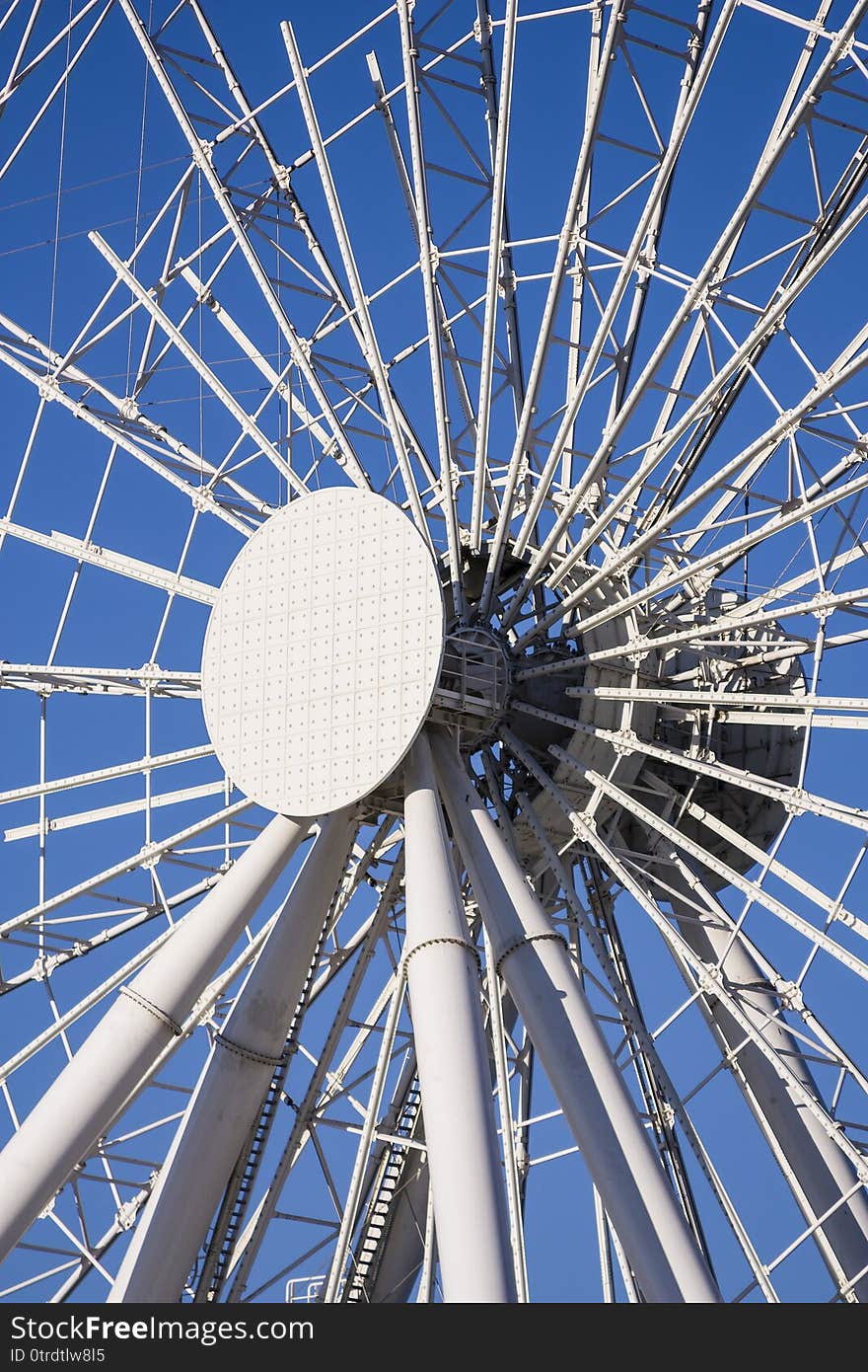 Big ferris wheel moves. Bright photo of the amusement park.  Ferris wheel in the park.