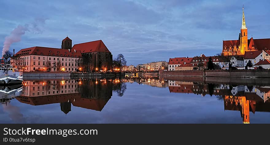 The City Wroclaw in Poland. With churches and great architecture by night and by day with reflection in the river of Oder