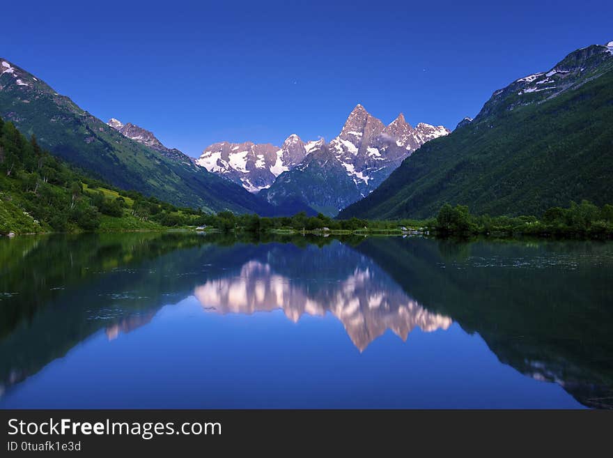 Evening on the lake in the mountains in the summer. Rosia. Dombay