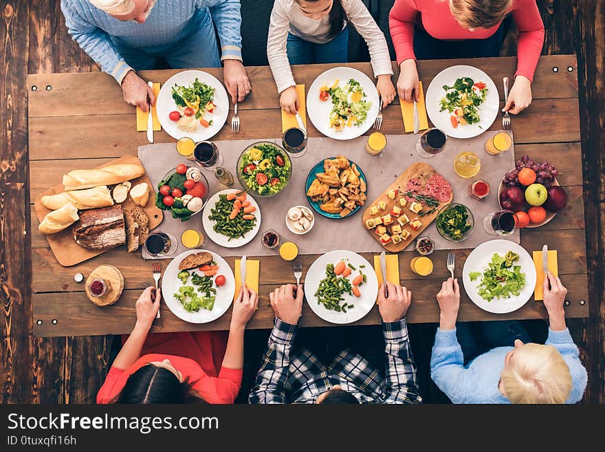 Every member of the big family eats. Festive table set for six people. Wooden background top view mock-up