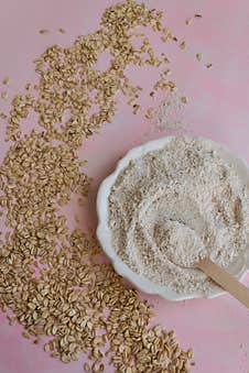 Oat Food Ingredients - Flour And Flakes On Pink Background Royalty Free Stock Images