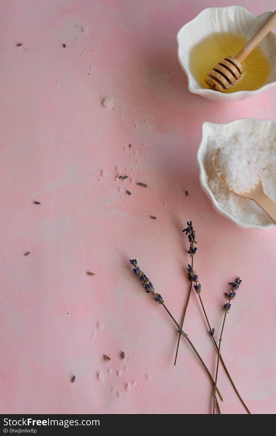 Natural wellness beauty ingredients on pink background. Health care spa therapy with honey, sea salt and lavender