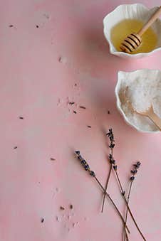 Natural Wellness Beauty Ingredients On Pink Background. Health Care Spa Therapy With Honey, Sea Salt And Lavender Stock Image