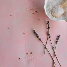 Natural Wellness Beauty Ingredients On Pink Background. Health Care Spa Therapy With Sea Salt And Lavender Royalty Free Stock Photography