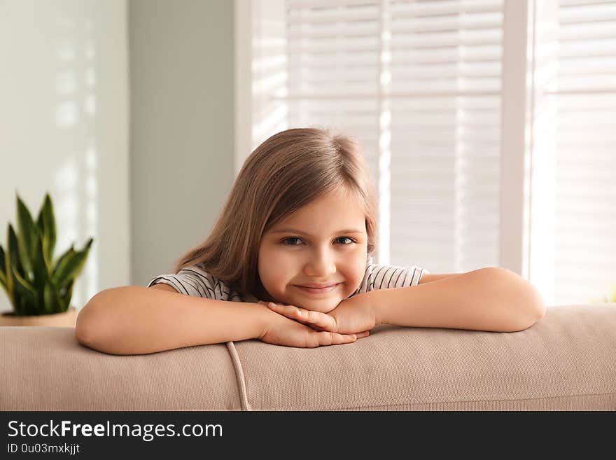 Cute little girl on couch at home