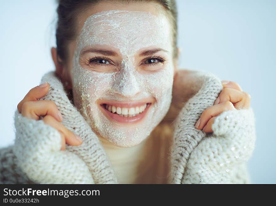 Smiling woman with white facial mask covering in clothes